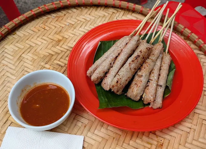 Nem Nuong Em Thuy is a popular spot for flavorful grilled fermented pork sausage rolls