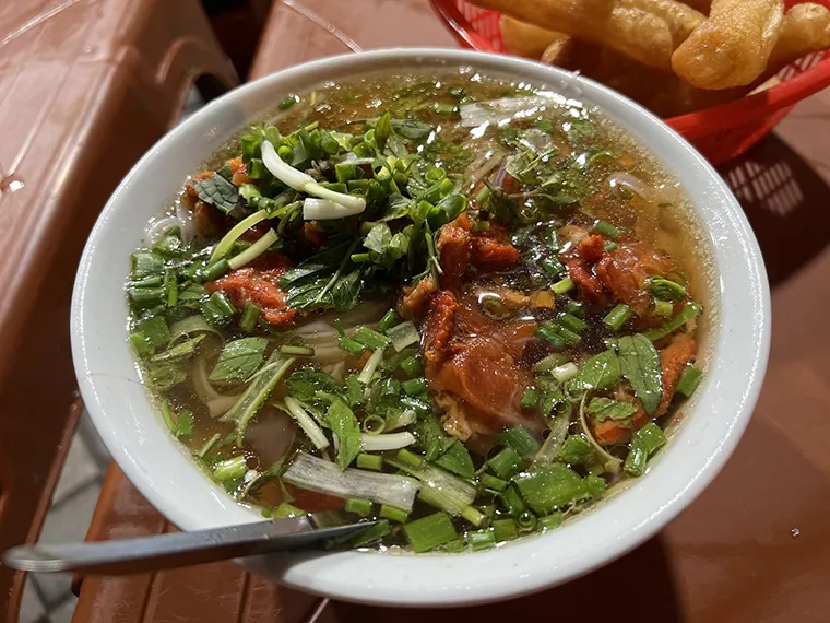 The pho broth has a light, clear sweetness, combined with the aroma of scallions, attracting diners from morning till night