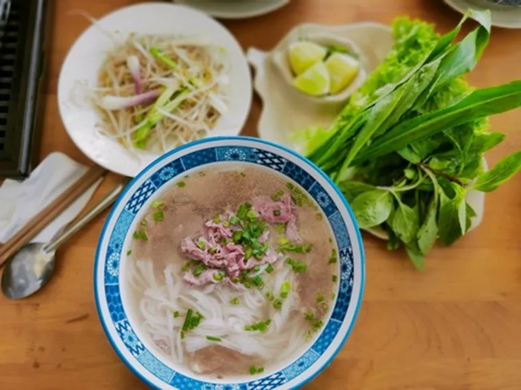 Savor authentic pho at a bustling local stall